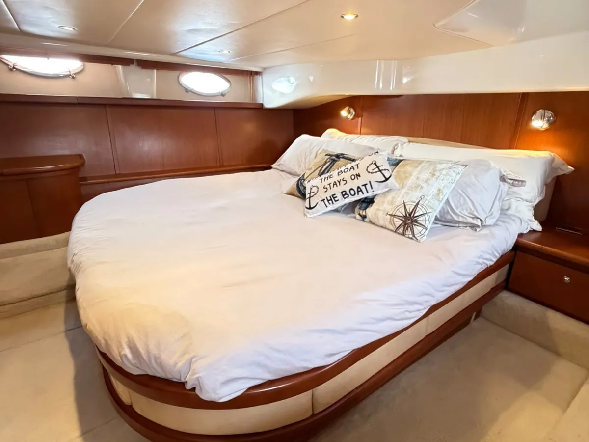 The second cabin: a big double bed with nautical cushions